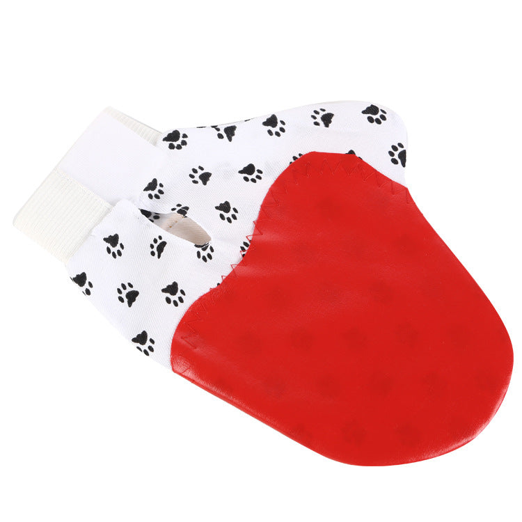 Pet deshedding glove removing loose fur while stroking a pet