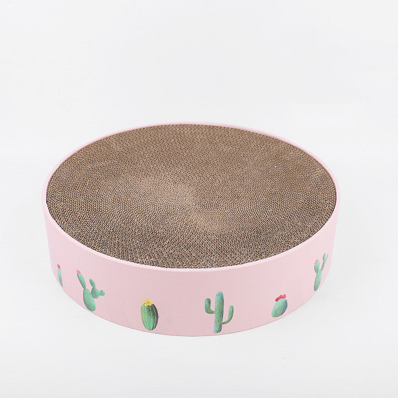 Cat scratching in a bowl-shaped cardboard scratcher bed