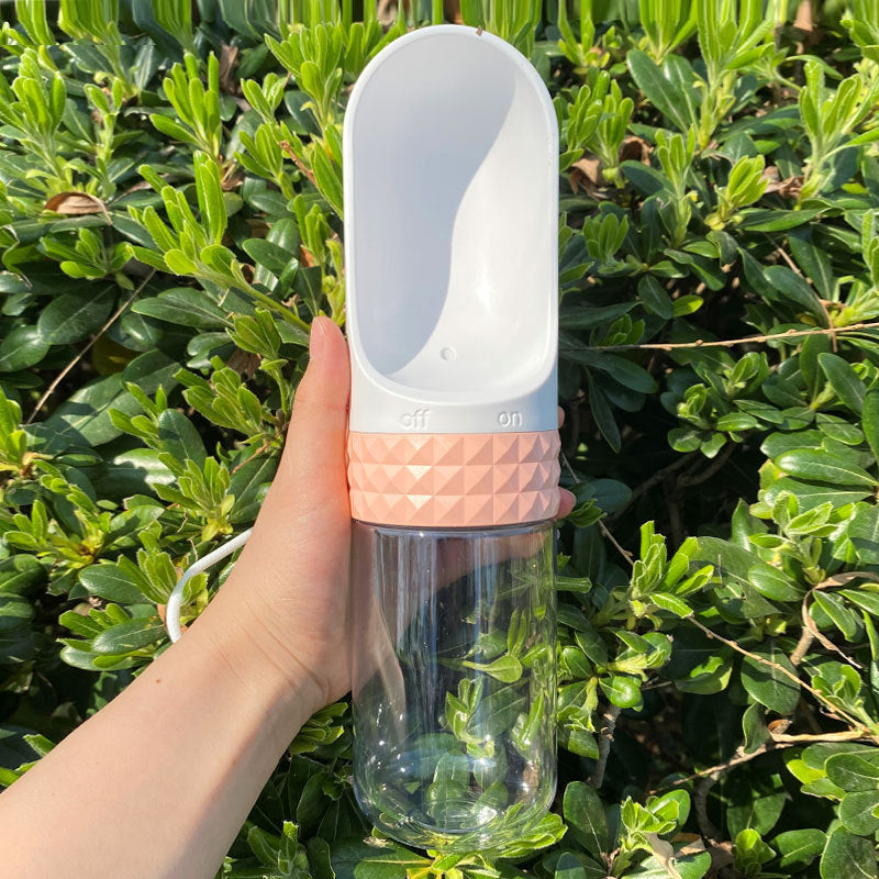 Pink dog travel water bottle with one-click dispenser