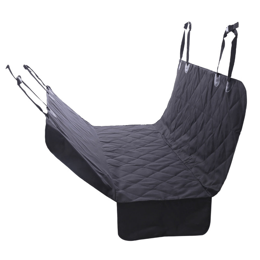 Dog relaxing in car seat cover hammock